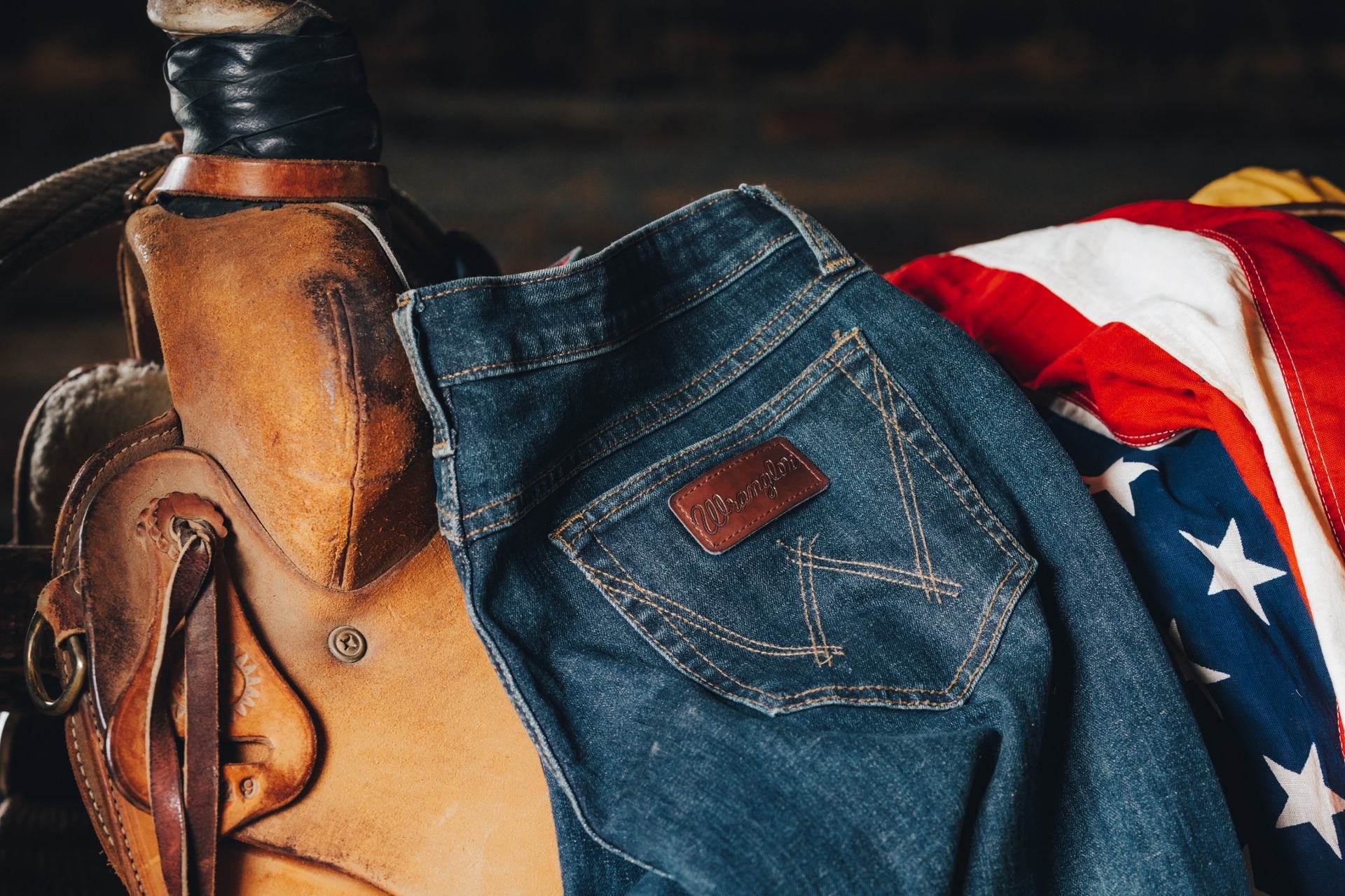 Wrangler Jeans On Saddle with American flag in backgroun