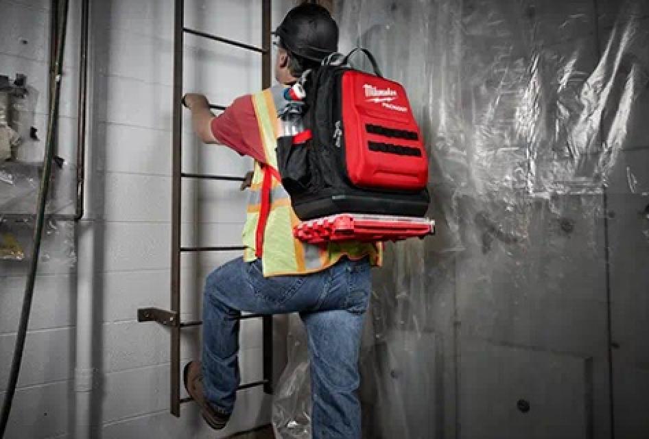 Milwaukee PACKOUT™ Backpack on Model Climbing Ladder